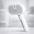 Steam grooming brush for dogs that detangles fur and reduces shedding at home